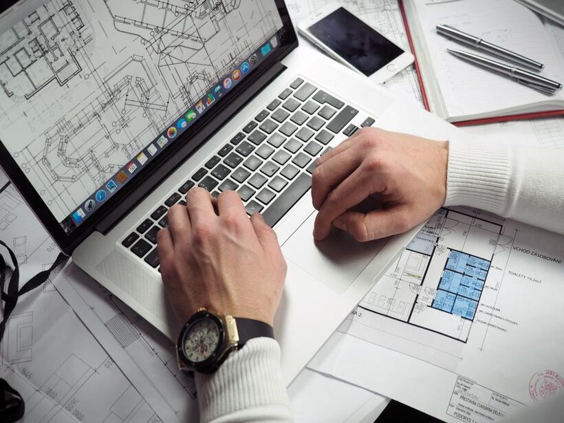 Two laptops side by side comparing apartment listing pages