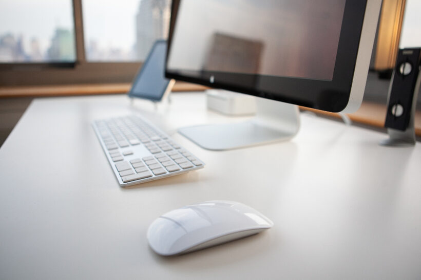 Leasing office desk with a laptop showing a community website