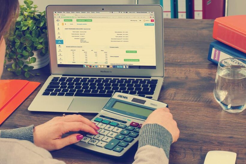 Spreadsheet and calculator on a desk during budget season